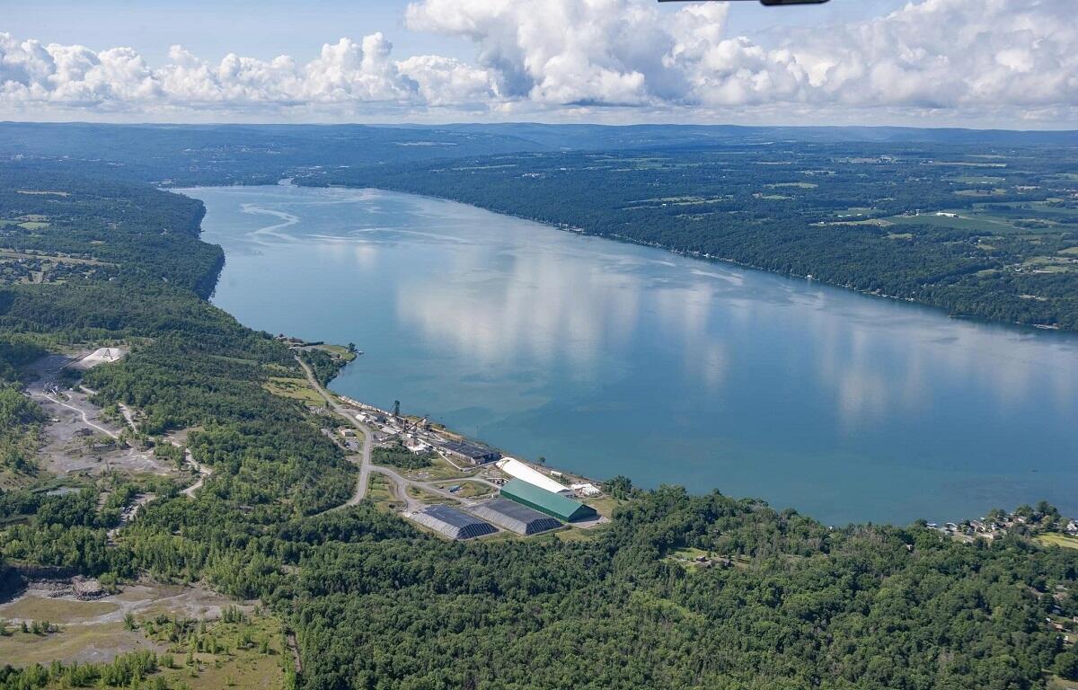 Aerial view of a wide river winding through forested countryside with an industrial complex along the near bank.](#)