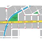 Map showing a parade route through a downtown area: yellow street (Cayuga St) as main path, red dashed lines indicate barriers, green parks (T13 DeWitt Park, Thompson Park), blue canal/stream, and surrounding streets labeled (Geneva St, Buffalo St, Tioga St, Utica St).
