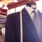 Navy suit on a mannequin with a measuring tape, in a tailor shop.