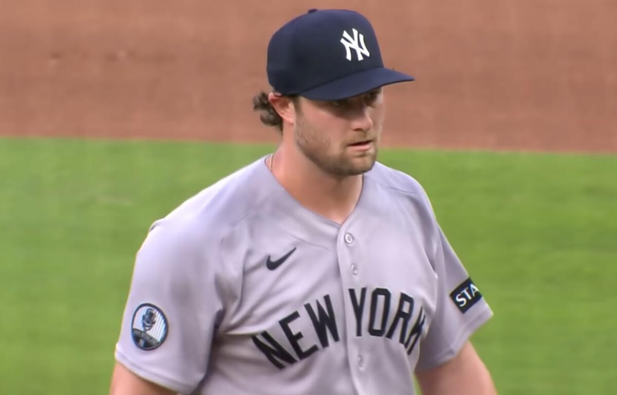 Baseball pitcher in a gray New York Yankees uniform on the mound during a game.