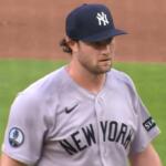 Baseball pitcher in a gray New York Yankees uniform on the mound during a game.