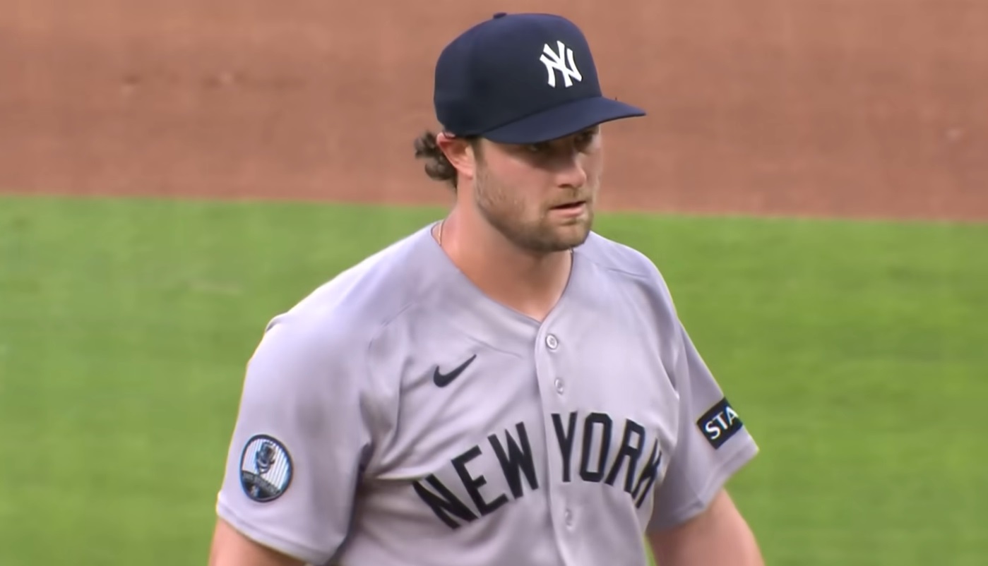 Baseball pitcher in a gray New York Yankees uniform on the mound during a game.