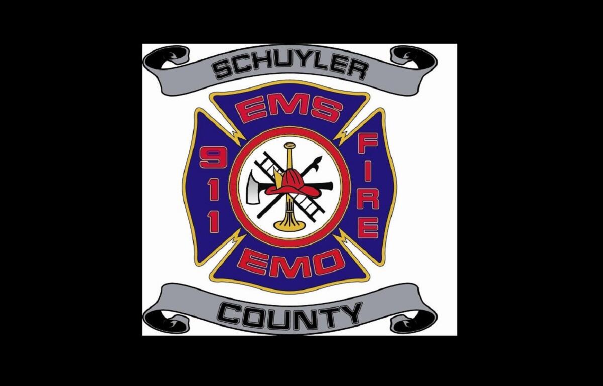 Schuyler County EMS/Fire badge with blue cross, center tools (axe, trumpet) and gray banners reading 'Schuyler' and 'County'