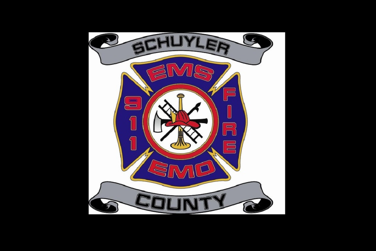 Schuyler County EMS/Fire badge with blue cross, center tools (axe, trumpet) and gray banners reading 'Schuyler' and 'County'