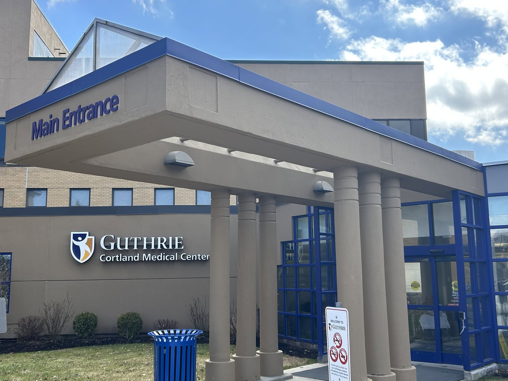 Main Entrance of Guthrie Cortland Medical Center with blue trim and glass doors.