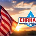 American flag waving at sunset beside the EHRHART Energy logo