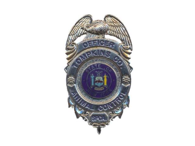 Animal control officer badge: State of New York insignia with an eagle and decorative shield marker, labeled 'Officer' and 'Animal Control' on the badge.
