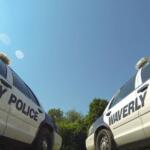 Two Waverly Police Department patrol cars parked on a sunny day, taken from a low angle.