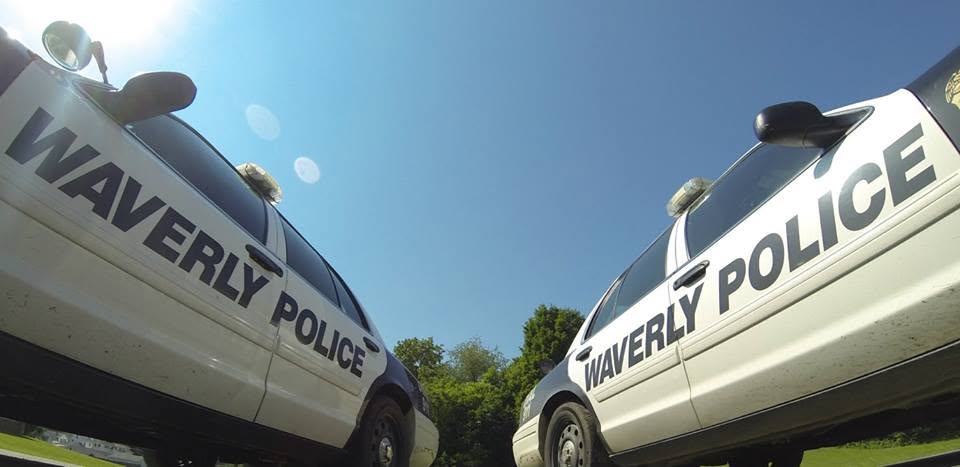 Two Waverly Police Department patrol cars parked on a sunny day, taken from a low angle.