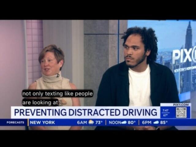 Two interview guests sit in a TV studio discussing distracted driving; on-screen headline reads 'PREVENTING DISTRACTED DRIVING'.