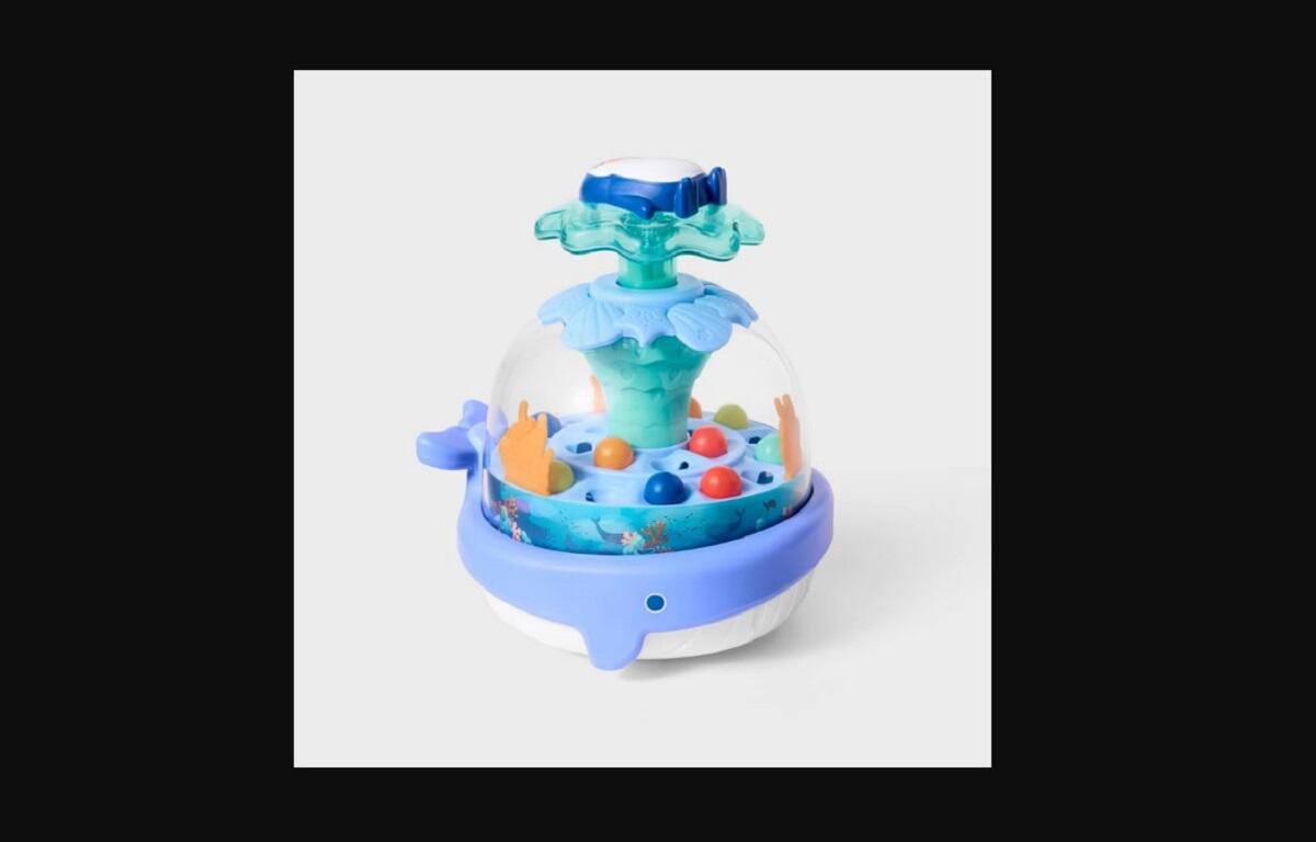 Colorful children's water play fountain with a blue base, clear dome, and multicolored balls inside.