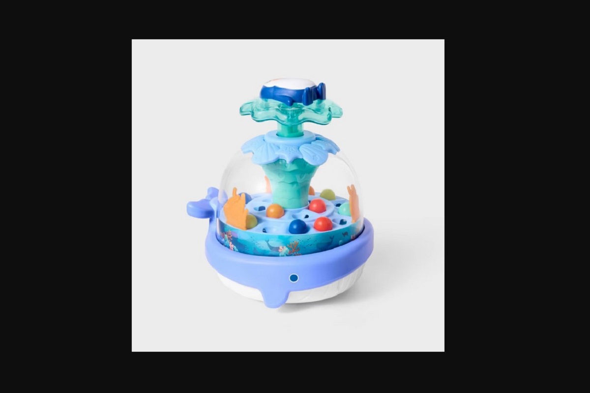 Colorful children's water play fountain with a blue base, clear dome, and multicolored balls inside.
